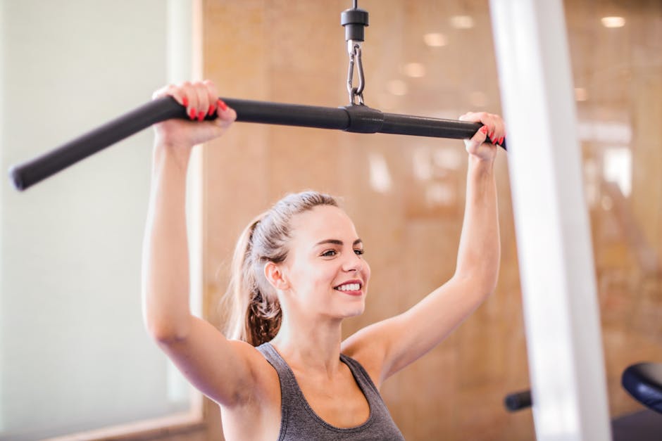 Smiling woman uses gym equipment for strength training indoors